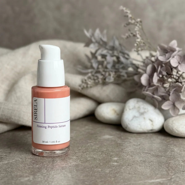 SIRELA Firming Peptide Serum bottle on a stone surface with flowers and stones in the background