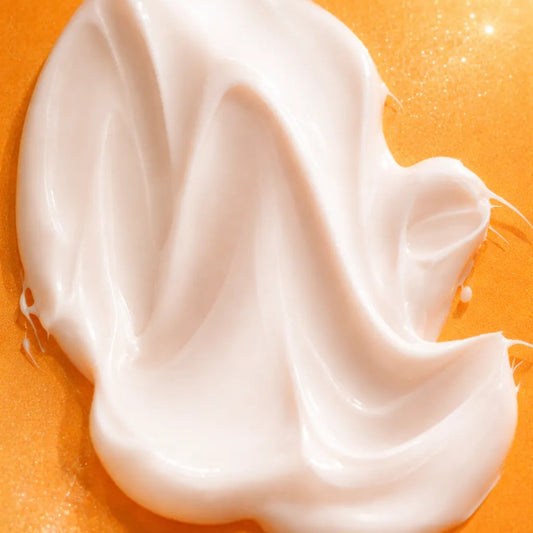 Sirela Firming Renewal Cream texture swatch in a premium macro shot showing a silky, rich cream finish on a warm background.