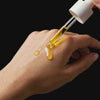 Video showing the smooth, golden texture of Sirela Bio-Retinol Concentrate being applied to skin for a radiant glow.